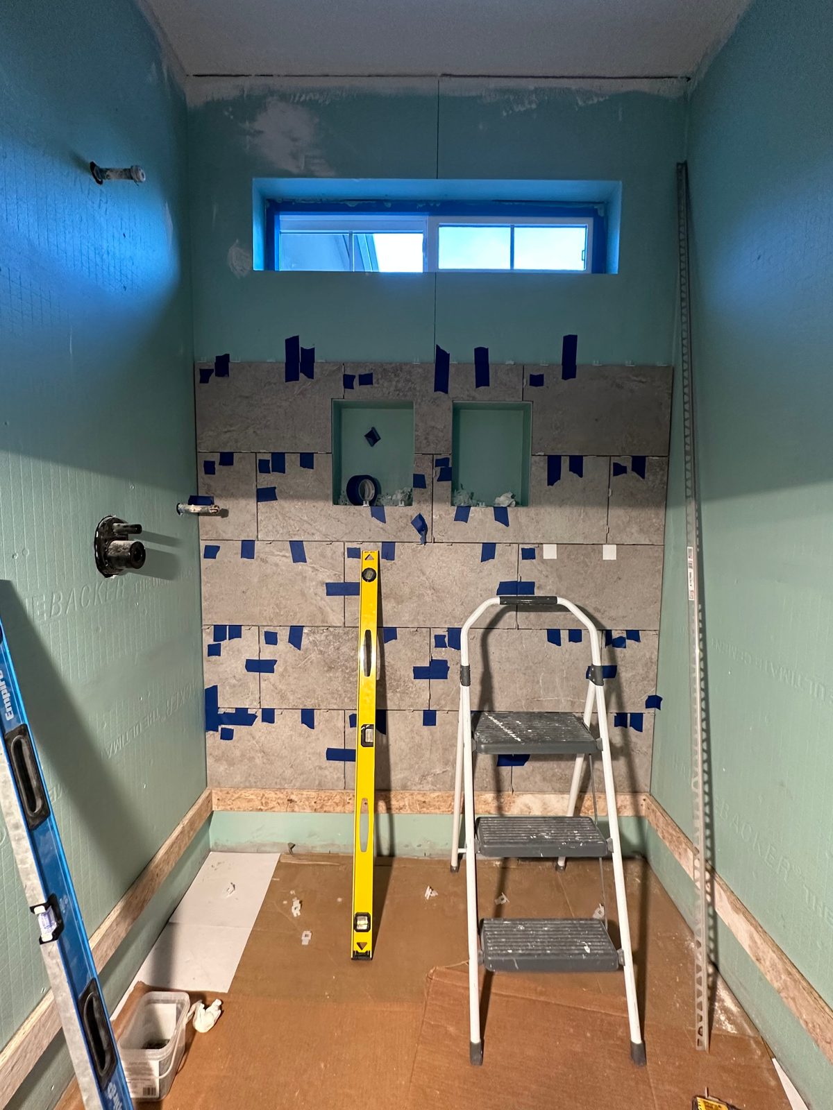 Shower wall preparation and tile installation in progress