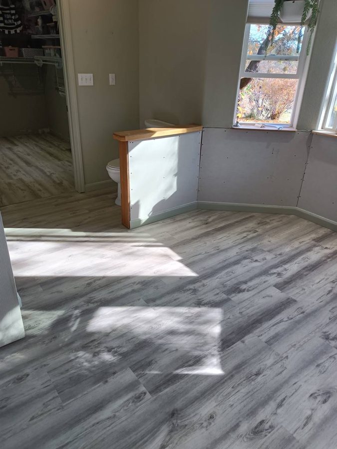 Fresh flooring through a remodeled bath suite